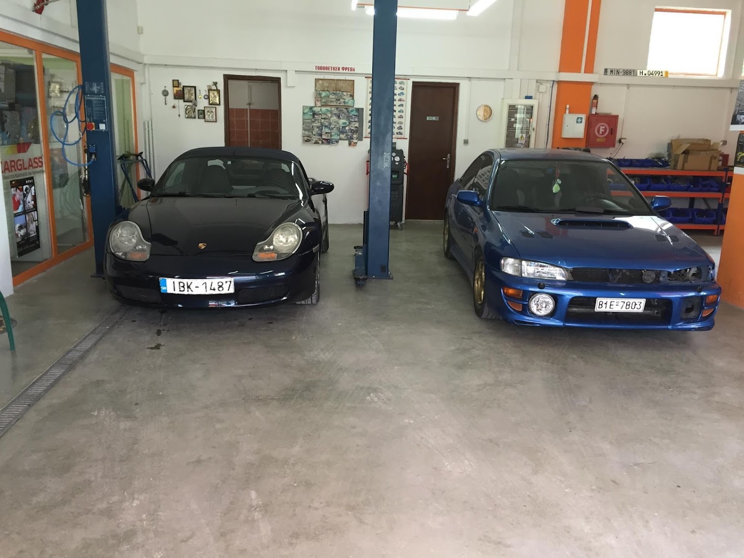 Workshop interior with Porsche and Subaru Impreza